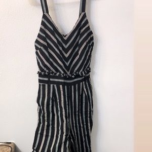 Black romper with ruffle detail